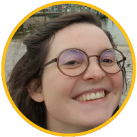 Smiling young woman with round glasses, outdoor headshot photo